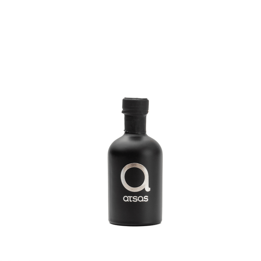 Black 'Atsas' olive oil bottle rotating around in. white background
