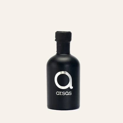 Black bottle with 'Atsas' logo on a white background