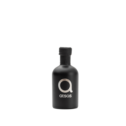Black 'Atsas' olive oil bottle rotating around in. white background