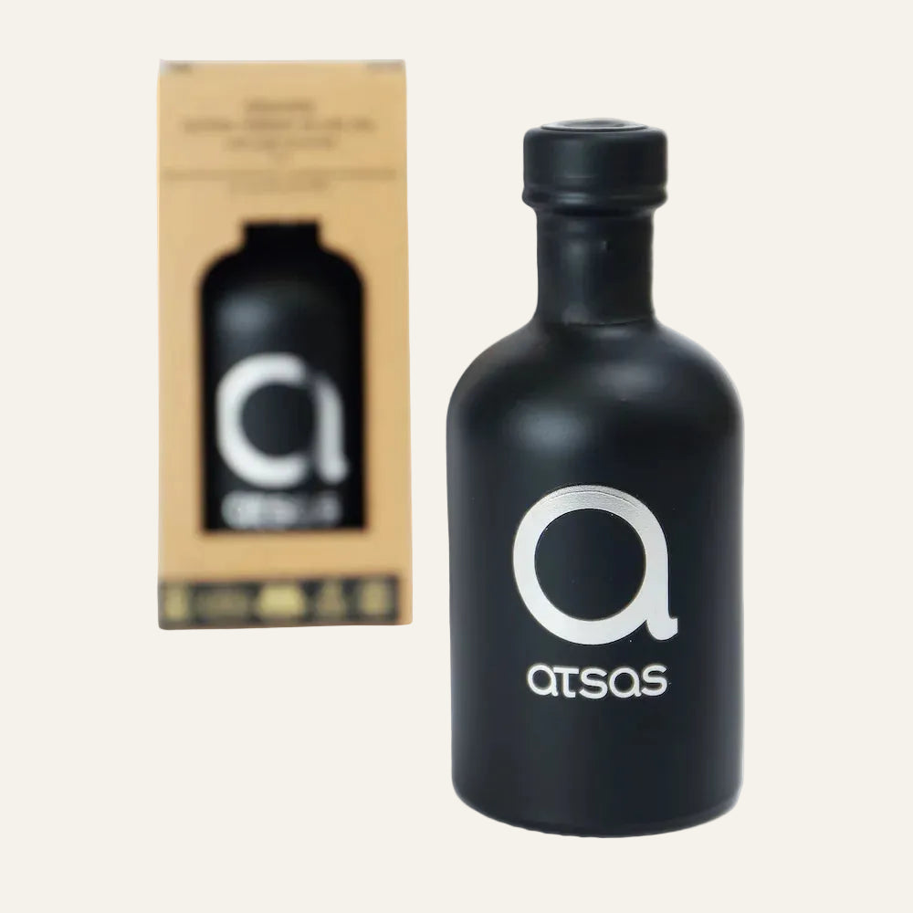 Black bottle with 'atsas' logo and packaging on a white background